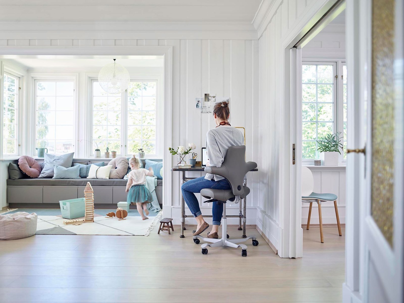 Een vrouw werkt thuis op een ergonomische stoel